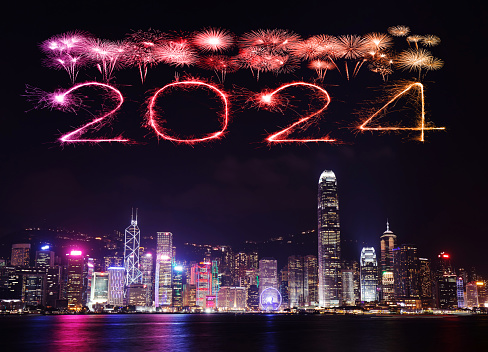 2024 Happy New Year fireworks over Hong Kong cityscape at the night.