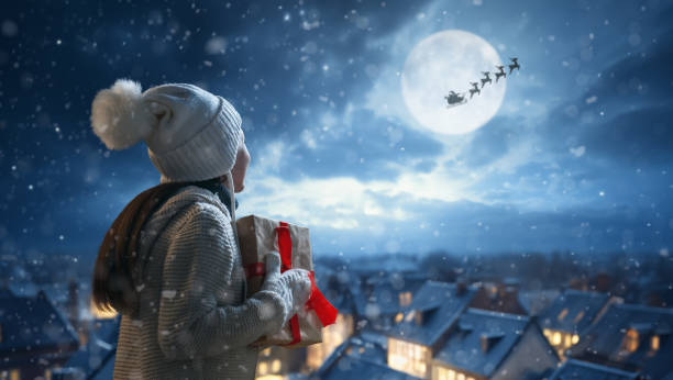 istock girl with present at Christmas 1794136641