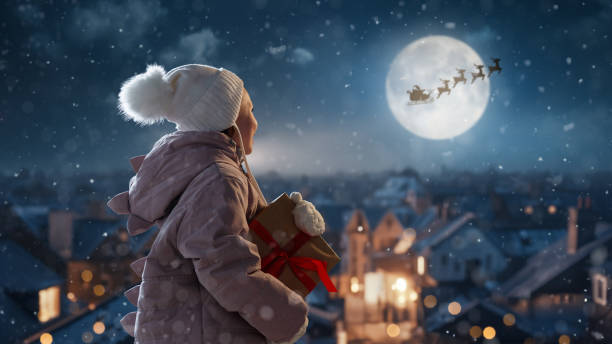 istock girl with present at Christmas 1794136887