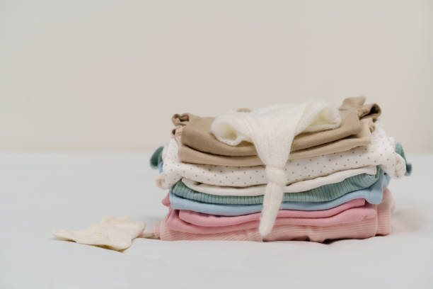 istock stack of baby clothes on bed 1794140619