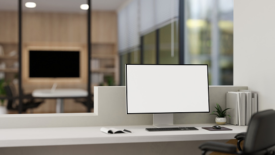 A white-screen computer mockup on a counter in a modern entrance door or office lobby reception. close-up image. 3d render, 3d illustration