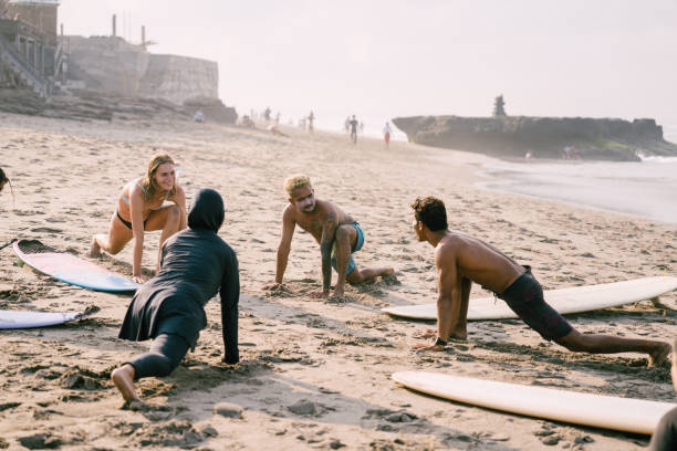 istock Group of Friends Warm up Before Surfing 1794172268