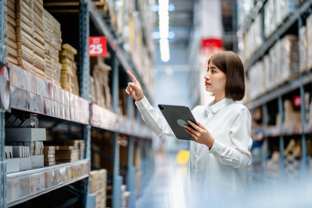 istock Women warehouse worker using digital tablets to check the stock inventory on shelves in large warehouses, a Smart warehouse management system, supply chain and logistic network technology concept 1794178586
