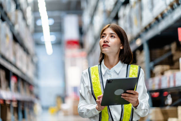 istock Women warehouse worker using digital tablets to check the stock inventory on shelves in large warehouses, a Smart warehouse management system, supply chain and logistic network technology concept 1794178589