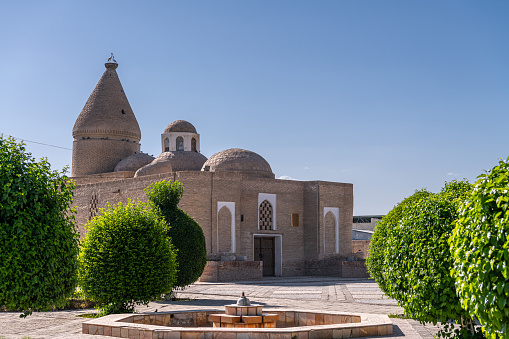 Chashma Ayub Mausoleum is located near the Samanid Mausoleum in Bukhara, Uzbekistan. Blue sky with copy space for text
