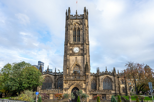 St Edward the Confessor's Church on Church Street at Leek in Staffordshire, England. The building dates to the 13th century. Commercial locations are on the place sign.