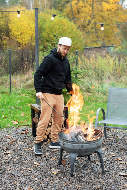 istock A man lights a barbecue in nature 1794225322