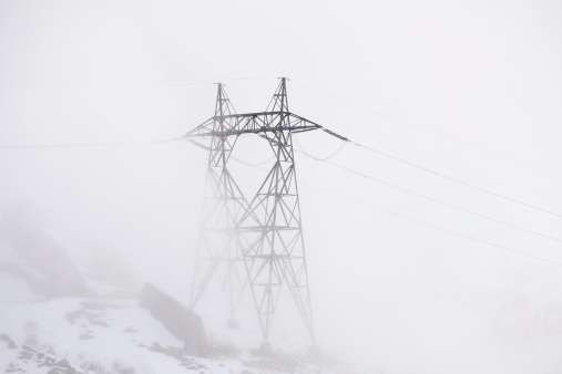 Electricity Pylon in the fog with snow
