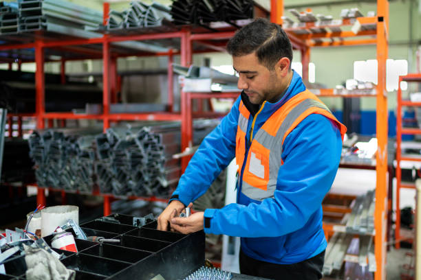 Warehouse male worker examining goods in factory