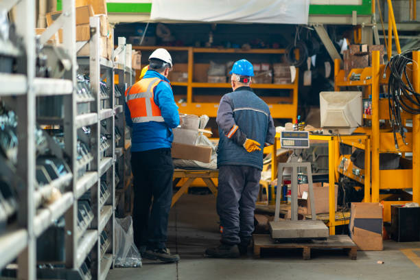 istock A back view of two workers wearing protective work clothes in the factory 1794244159