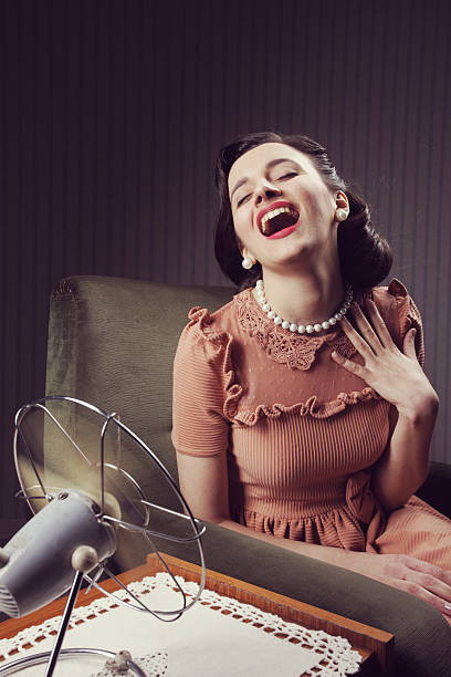 istock Woman cooling herself with fan 179427220