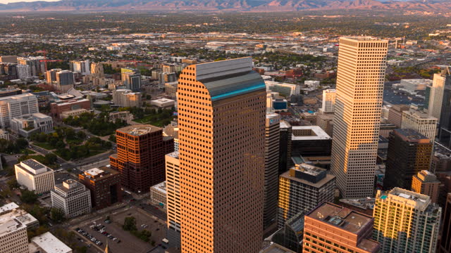 Iconic Wells Fargo Center in Denver at sunset, aerial riser hyperlapse