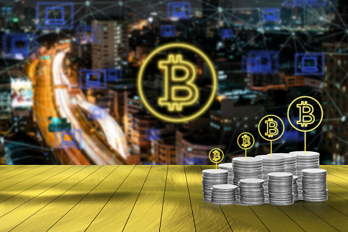 Digital money with bitcoin symbol and network connection concept with blurred cityscape background