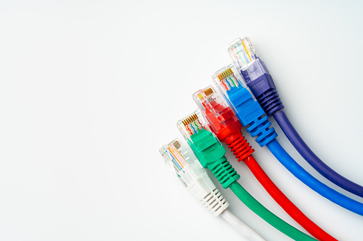 Colorful network cables switch on white background close up