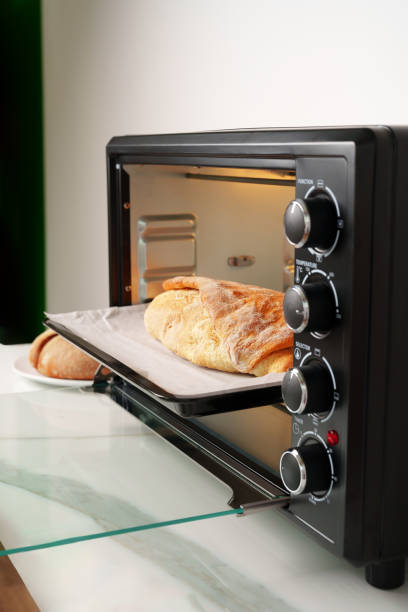 istock Freshly baked bread in mini oven in the kitchen 1794331873
