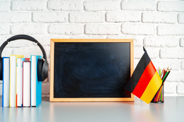 istock Blackboard and German flag on school desk 1794331881