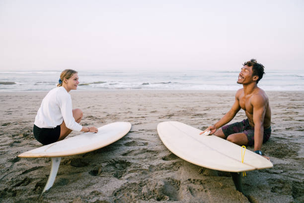 istock Young Couple Preparing Surfboard Together Before Surfing 1794334534