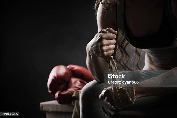 Woman Boxer Wrapping Bandage Around Hand Prior To Game Stock Photo - Download Image Now