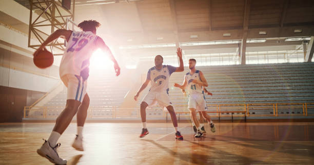 istock Men playing basketball on court 1794334559