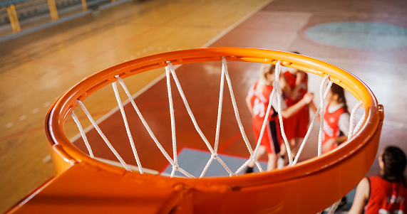 Close-up of empty basketball hoop in stadium.