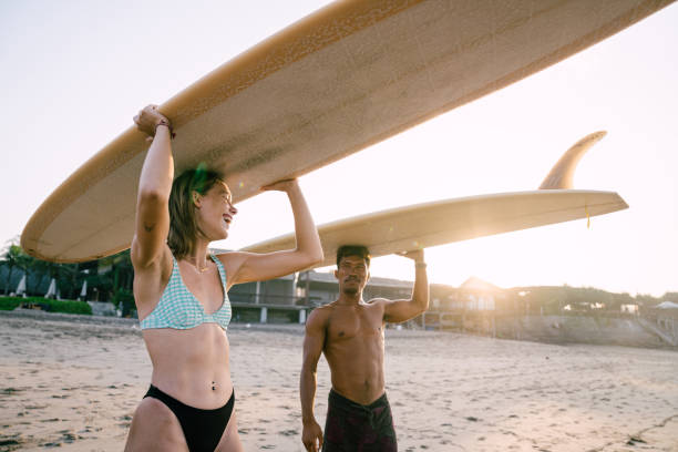istock Beautiful Couple Ready for Surfing 1794335145