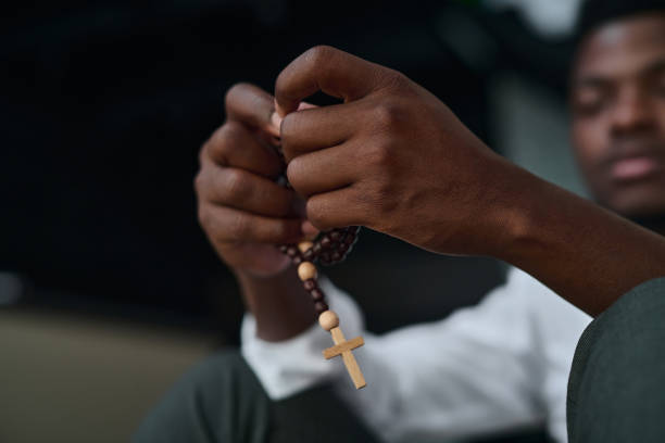 istock Man sitting with rosary beads 1794341639