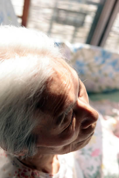 Close-up of an elderly woman's face with a depressed expression