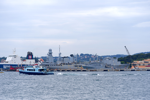 Navy frigate enters a harbour after offshore training exercises.