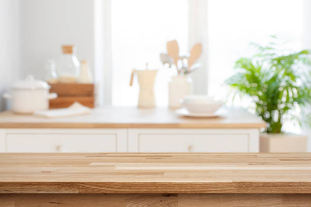 istock Empty wooden table for product display on blurred kitchen counter interior background 1794390355