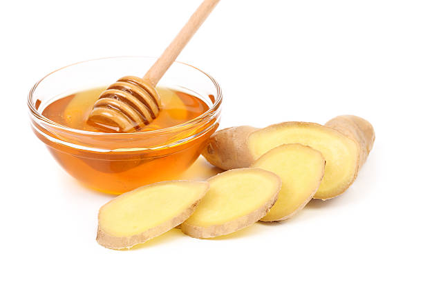 istock Root Ginger sliced and bow of honey. 179443169