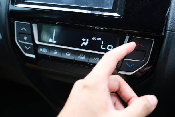 A car driver hand adjusting the air conditioner temperatur A car driver hand adjusting the air conditioner temperatur temperatur stock pictures, royalty-free photos & images