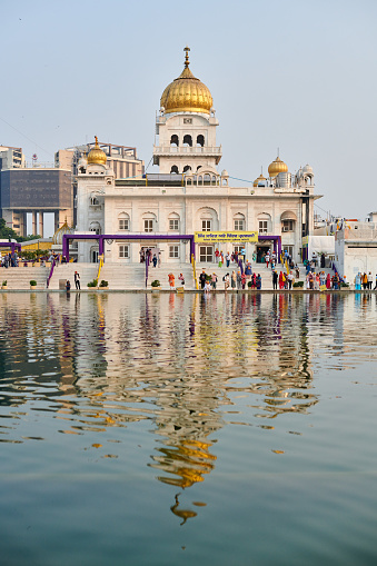 New Delhi, India - 10.11.2022 - Sikh temple Gurudwara Bangla Sahib holy pond Sarovar in New Delhi, beautiful Sikh house of worship popular touristic spot in Delhi, pilgrims in Sikh gurudwara complex