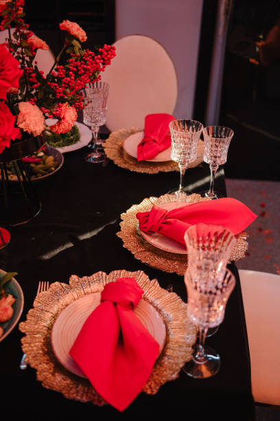istock Serving guests, setting table. Two plates, silverware cutlery, red linen napkin. Wedding set up. Flat lay. Top view. Close up. Served banquet food, glasses, forks. Luxury reception for birthday party. 1794483156