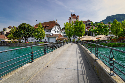 Thun, Switzerland - June 23, 2023: The city center of Thun, Switzerland with view of Castle Thun. It was built in the 12th century and is a Swiss heritage site of national signif. Switzerland travel and landmarks.