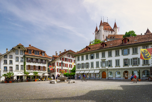 Thun, Switzerland - June 23, 2023: View of City Hall square and castle of Thun under picturesque sky. Thun city is a popular travel destination and tourist attraction in Switzerland, Kanton Bern.