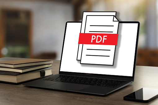 PDF button on screen Laptop computer converting process of document to another format Convert PDF files with online programs.