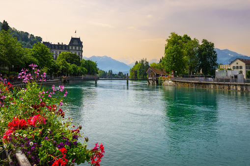 Beautiful Thun city, Lake Thunersee, swiss alps, Switzerland. Bridge in the Aare river in historic downtown with mountains in the background. A walk through the city