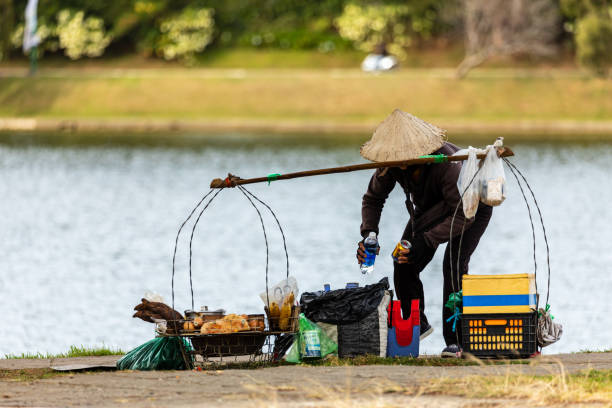 woman is carry at bbq grill as a street restaurant in da lat - asian cuisine food asian ethnicity vietnamese cuisine imagens e fotografias de stock