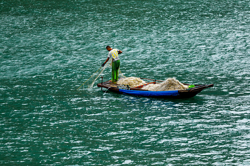 Ha Long Bay, Hai Phong, Vietnam - October 31, 2019: Fisherman in the Ha Long Bay