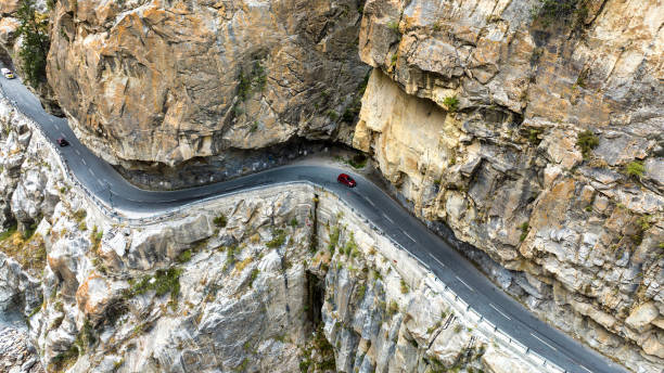 istock Bird eye view of a road cut through rocks along a river 1794514868