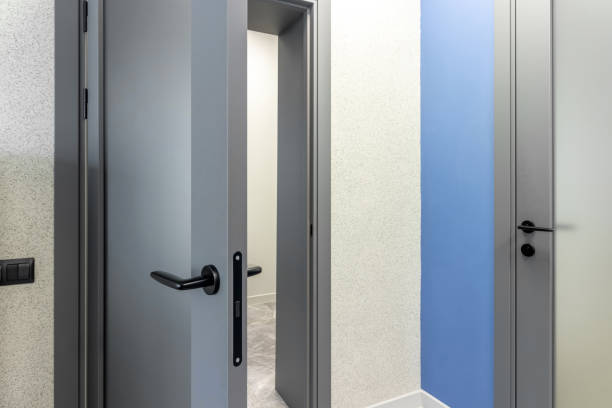 istock Grey door with glass insert in office building 1794530532