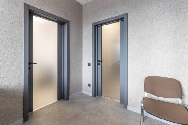 istock Grey door with glass insert in office building 1794530541
