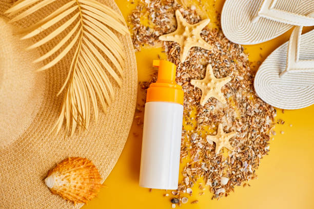 istock Flat lay, top view Sunscreen tube mockup with shells, sand yellow background, summer vacations and spf uv-protecting skin care concept 1794548023