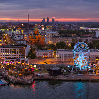 Aerial view of downtown Helsinki on a summer night, with a view towards the quay, skywheel and Uspenski Cathedral.