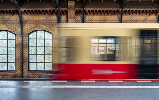 Germany, Berlin, October 15, 2023 - Blurred motion of Berlin S-Bahn train arriving at station, Berlin Tiergarten