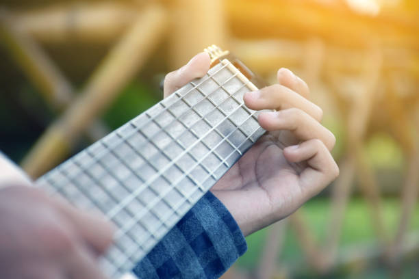 istock Closeup hands playing acoustic guitar. 1794564288