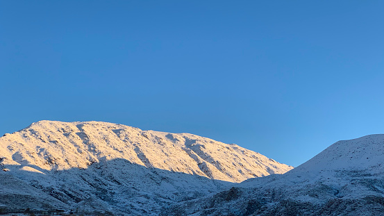 A panorama photo of Hoverla mountain with snow on it. View from above of Carpathian mountains