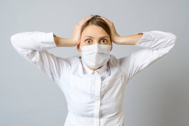 istock Surprised doctor in mask isolated on gray 1794580184