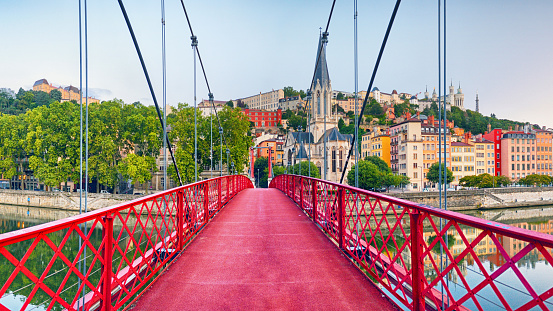 Panoramic view of Lyon with Saint Georges footbridge over Saone river at sunrise, France