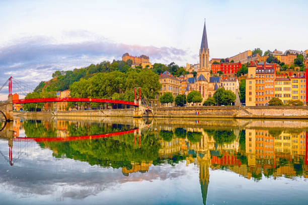 Panoramic view of Lyon with Saint Georges footbridge over Saone river at sunrise, France